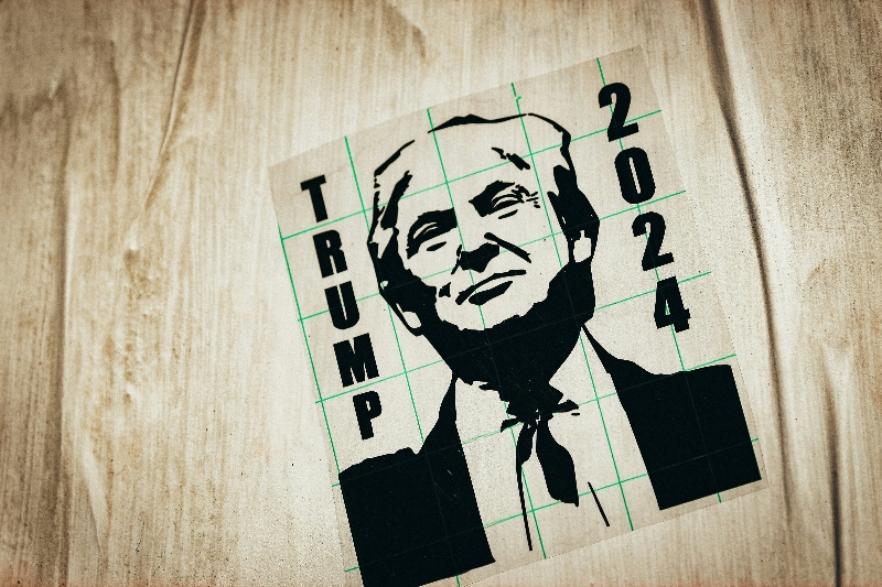 A Donald Trump 2024 sticker displayed on a wooden surface