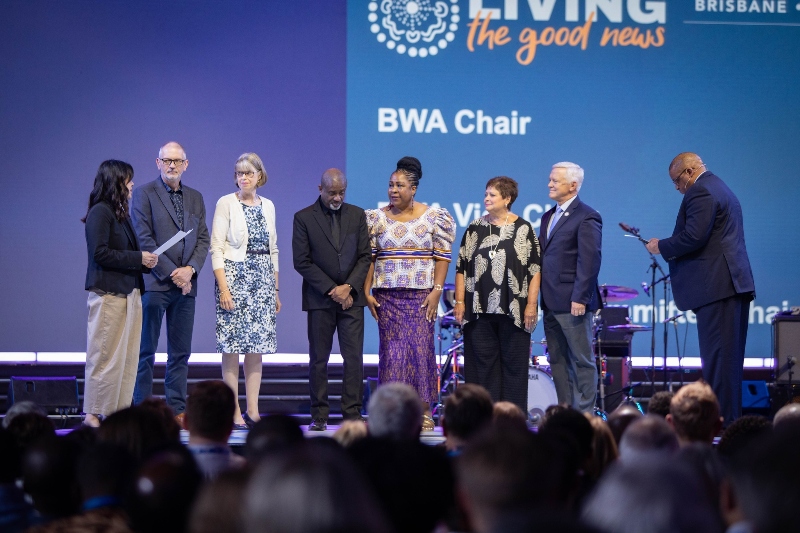A diverse group of people standing on stage, at the Baptist World Congress, being commissioned as members of the new BWA leadership team