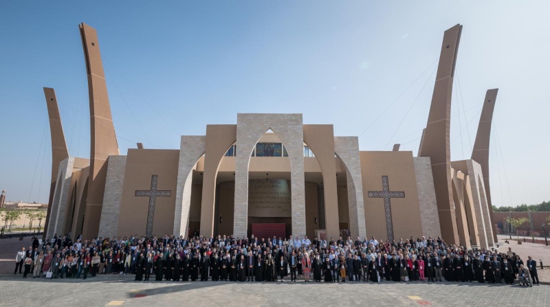 The 400 participants of the conference stand outside the venue, the Logos Papal Center, of the Coptic Orthodox Church, in Wadi El Natrun, Egypt