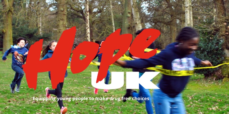 Hope UK website banner, featuring children running a race, with a Hope UK logo over the image
