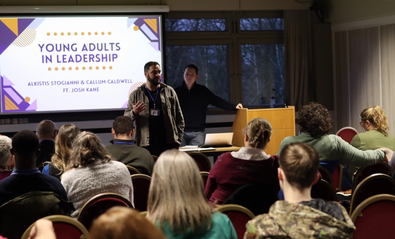 Fresh Streams Young Adults seminar - two men at the front speaking to a hall of people