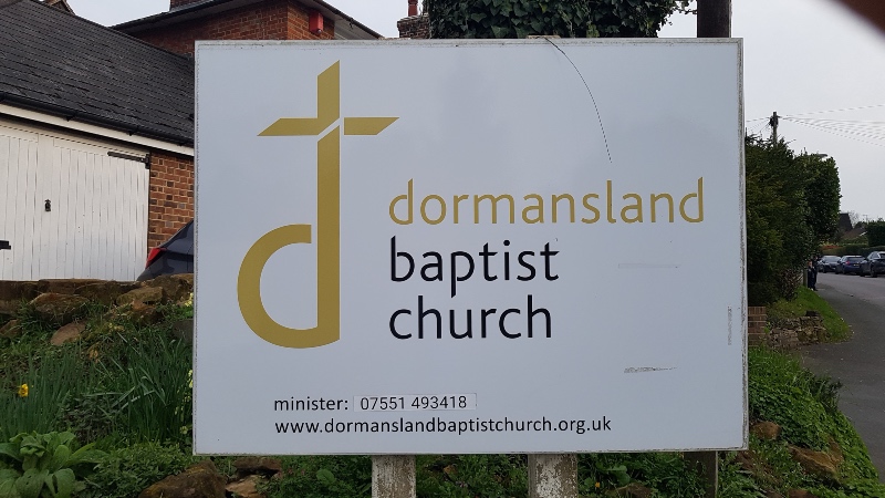 The sign for Dormansland Baptist Church, which contains the phone number and the church website